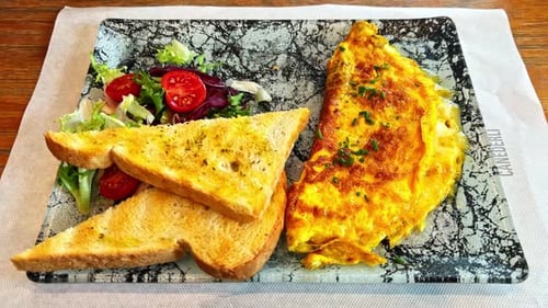 Cheese Omelette with Toast and Side Salad Closeup Lunch Plate