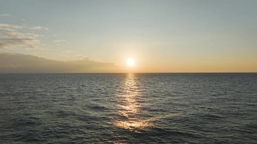 Aerial Video Mesmerizing Sunset with Golden Rays Reflecting on the Sea s Calm Surface