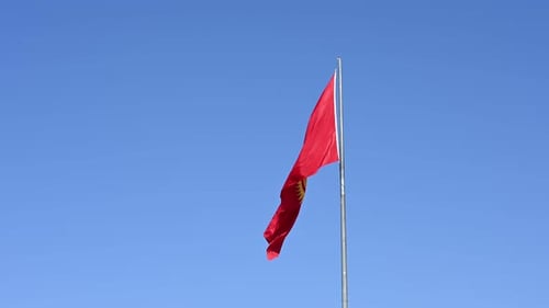 Flag Waving Gently Against Blue Sky