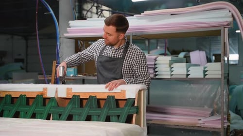 Man Using Staple Gun Building Couch Frame