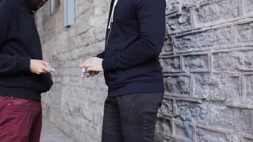 Addict buys dose from drug dealer on street in illegal drug trafficking trade