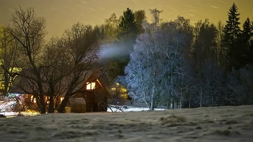 Remote farmstead with glowing lights and Milky way above, time lapse