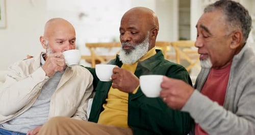Three Senior Men Enjoying Coffee Together Indoors