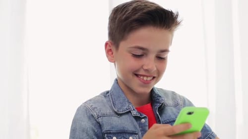 Smiling Boy Using Mobile Phone