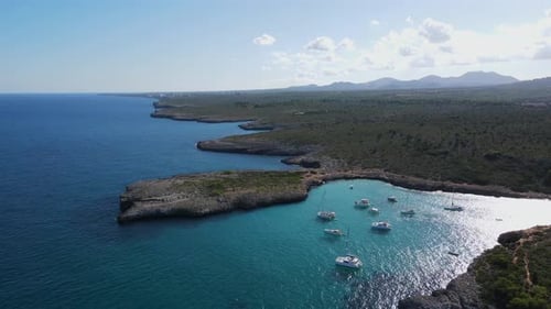 Explore Cala Varques in Majorca with stunning coastline and beautiful boats