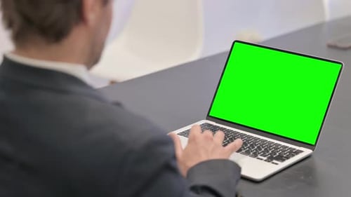 Businessman Using Laptop with Green Screen