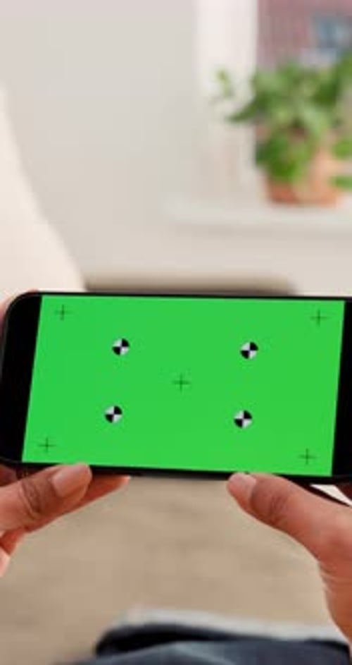 Hands, green screen and person on couch with phone, online entertainment and browsing at home