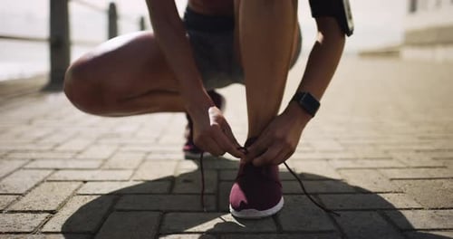 Woman Tying Running Shoe Getting Ready to Run