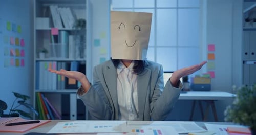 Businesswoman wear draw happy mask paper craft bag dance feel enjoy with success work in office.