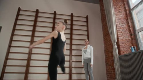 Graceful Learner in Activewear Outstretching Arms and Whirling in Gym