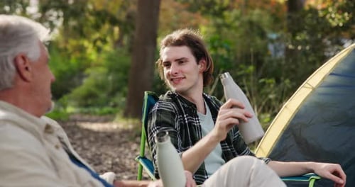 Adult and Young Adult Camping Together Outdoors