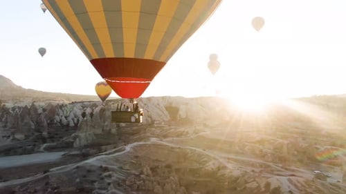 Hot Air Balloons Flying Over Unique Landscape at Sunrise