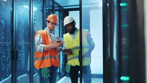 Professional Specialists are Diligently Inspecting the Infrastructure of a Modern Data Center