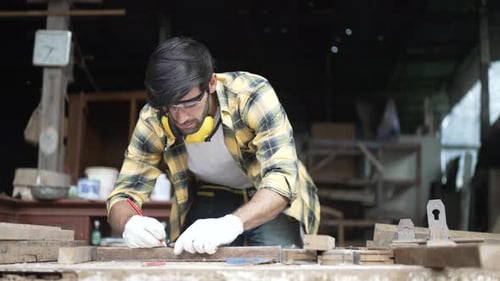 Carpenter make furniture at workshop.