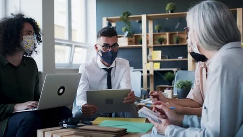 Business Team Meeting in Modern Office with Face Masks