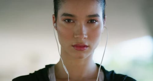 Focused Woman Wearing Earphones