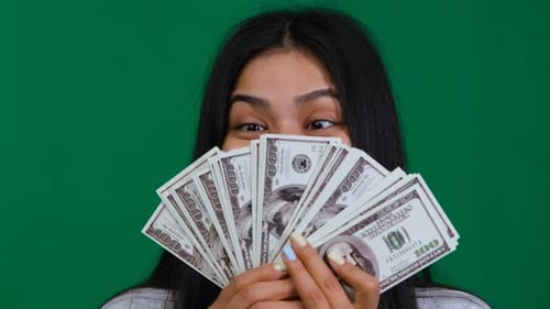 Financial Triumph Woman in the Studio Beaming with Happiness and Success Reflecting on Her
