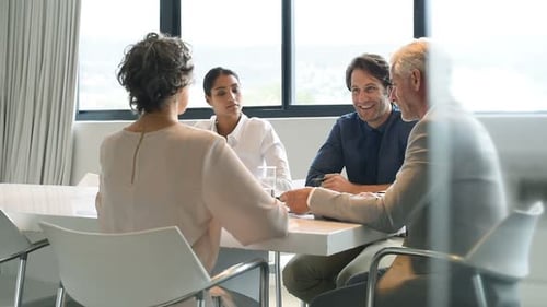 Business Team Meeting and Handshake in Modern Office
