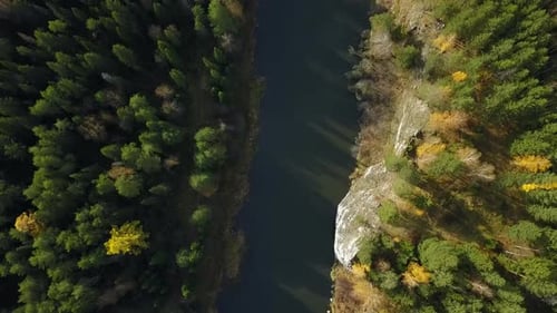 A Breathtaking Aerial View of a Serene River Beautifully Surrounded By Vibrant Autumn Forests Stock