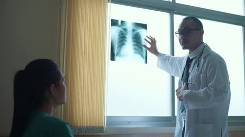 Doctor Explains X-Ray to Patient in Hospital