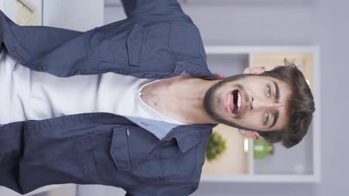 Vertical video of Man having a nervous breakdown in front of the camera.