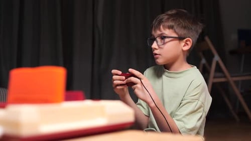 Boy Plays Vintage Game Console