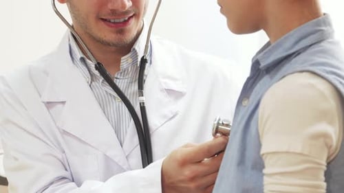 Doctor Checking Child with Stethoscope in Bright Room