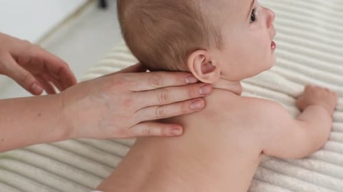 Closeup Top View of Loving Mother Hands Massaging Little Baby Close Up Cropped Shot of