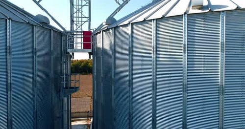 Elevated View of Gleaming Grain Silos in Rural Setting
