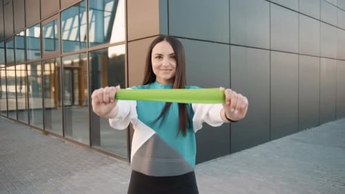 Woman Exercising with Resistance Band Outdoors
