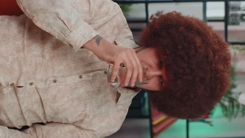 Man With Afro Drinking Water Indoors