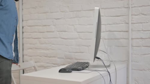 Mixed Race Man Coming Office to Work on Computer