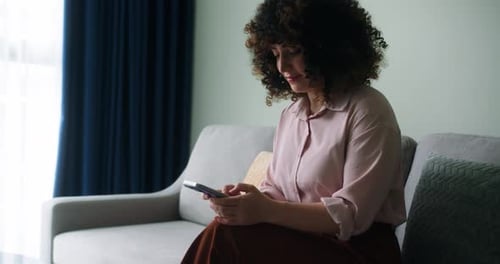 A Woman Typing on Mobile Phone Screen and Chatting in Living Room Woman's Hands Using Text Messages