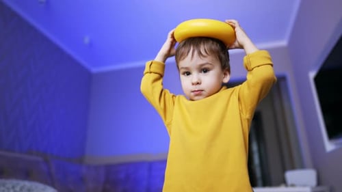 Boy Playing with Toy Ring at Home