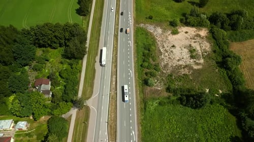 Aerial View of Vehicles on a Busy Highway in Green Countryside Highlighting a Scenic Journey Through