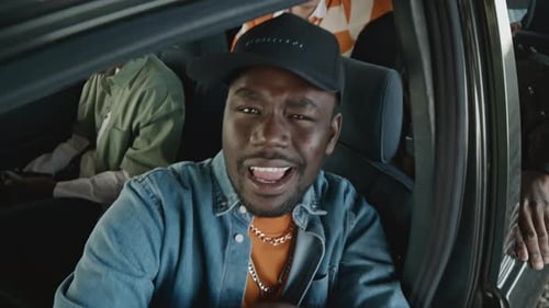 Young Adult Singing in a Car