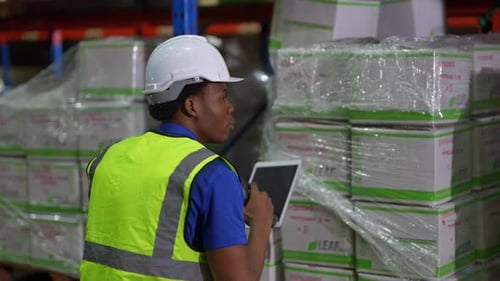Worker Doing Inventory in Warehouse. Dispatcher in uniform making inventory in storehouse. supply ch