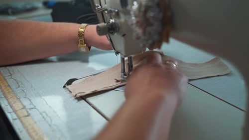 Woman Using Sewing Machine to Assemble Fabric