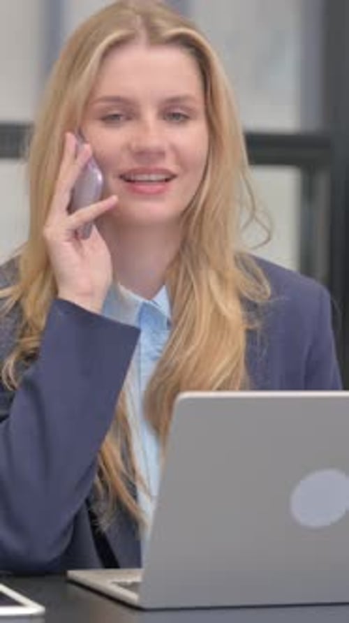 Woman Talking on Cell Phone in Office