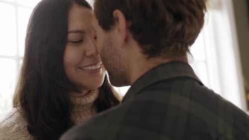 Loving Couple Embracing Indoors Near Window