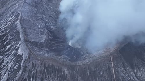 aerial view flying to mount Bromo active volcano above sea of clouds, Java, Indonesia