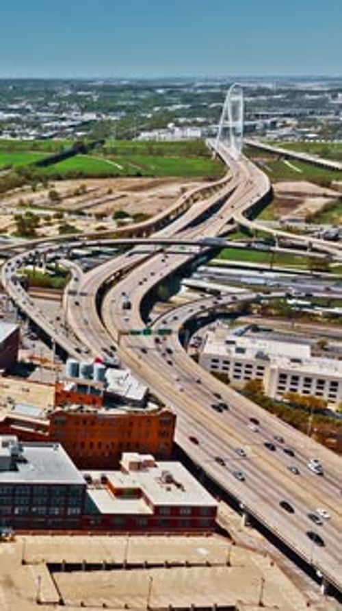 Dallas skyline reveals highways and green spaces in aerial view