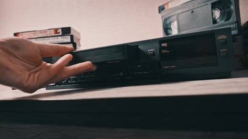 Insert VHS Cassette Into VCR Player