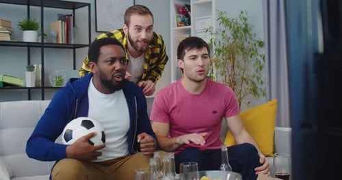 Excited Men Watching Soccer Game Together Indoors