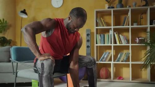 Muscular Man Lifting Dumbbell During Home Workout