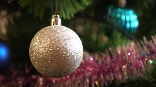 Silver Bauble Hanging on Christmas Tree
