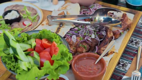 Appetizing overhead shot of delicious grilled meat and salads