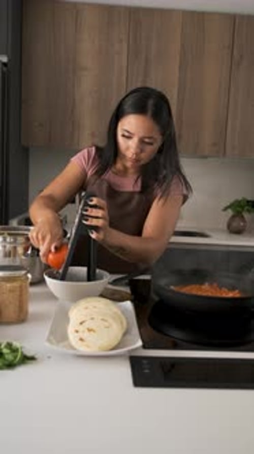 Woman Cooking a Meal in Modern Kitchen