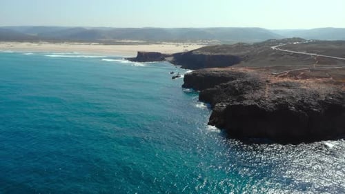 Scenic Coastal Panorama Aerial View of Sandy Coast with Vibrant Turquoise Waters and Serene Horizon