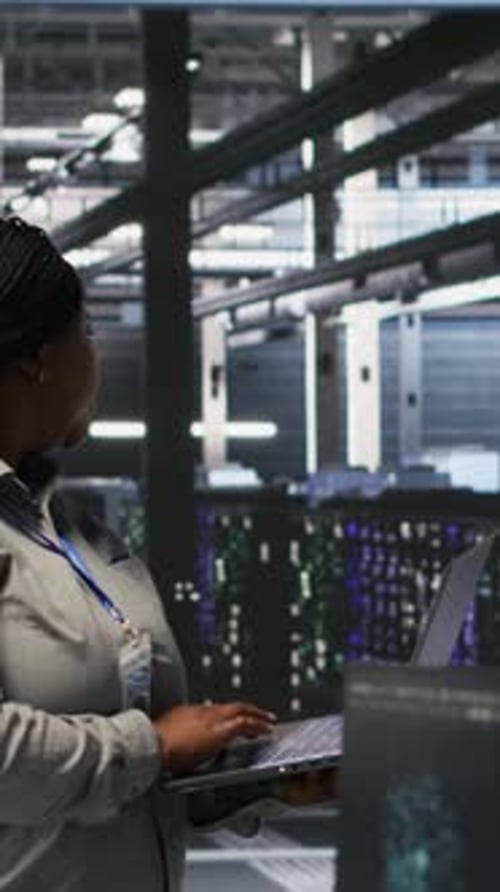 Vertical Video Data Center Engineers Performing Maintenance on Servers Used for AI